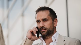 A businessman using his smartphone outdoors, showcasing the seamless integration of technology and