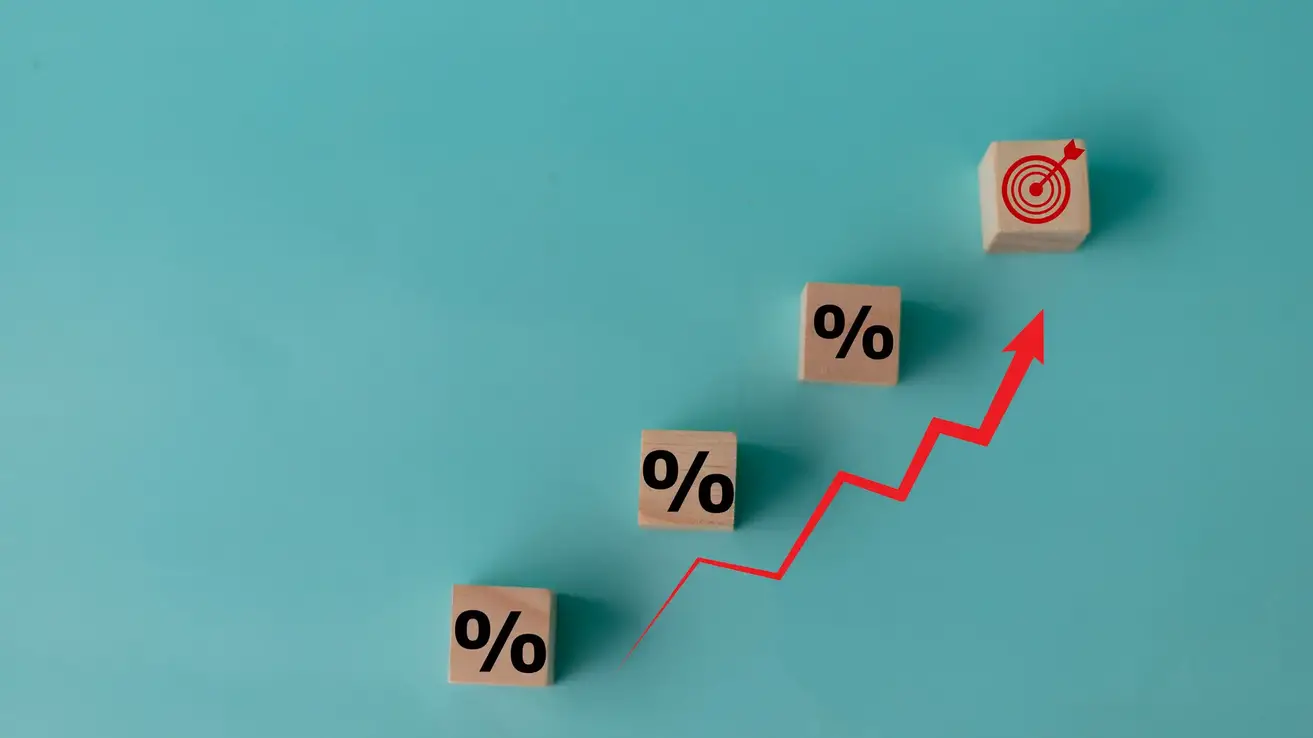Concept of increasing sales. Wooden cubes with percentage icon and Rising arrow red